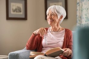 Life Assure Senior Woman Sitting In Chair And Laughing With Caregiver Nurse Blog